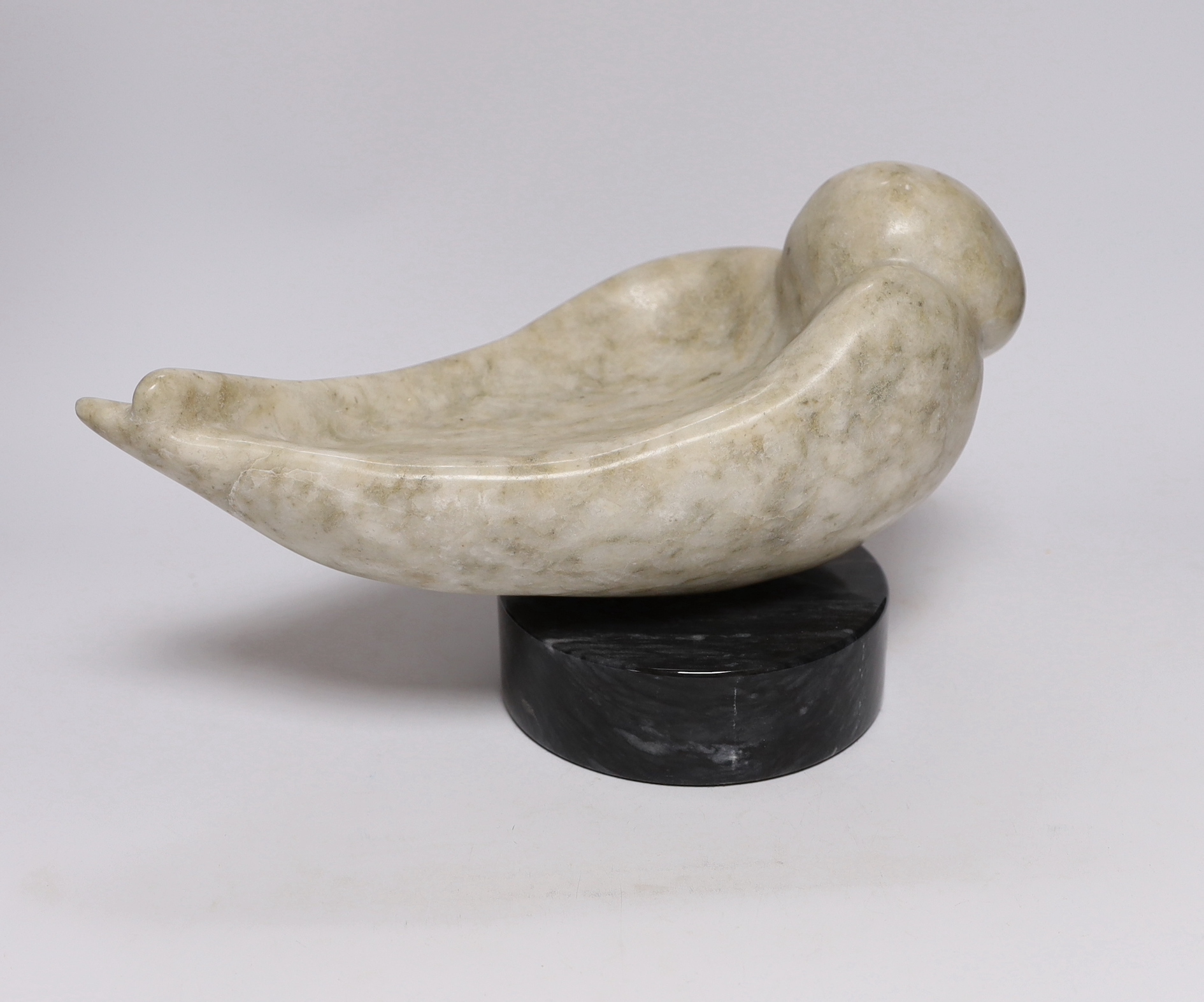 A Shona stone carving of a bird, possibly by Ignatius Zhakawayi, on a marble base, 35cm long